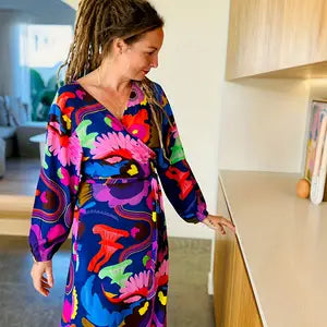 Introducing our must-have Plus Size Graphic Print Long Sleeve Surplice Neck Belted Dress!